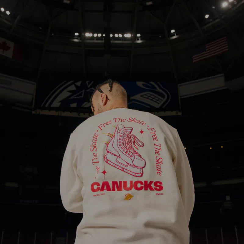 Man wearing an In-House designed T-shirt, standing confidently against a black backdrop.