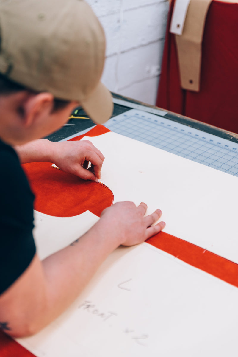 Pattern templates being used by In-House to draft garment pieces on fabric.