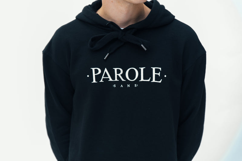 Model wearing a Parole branded hoodie showing precise front logo placement designed by In-House.